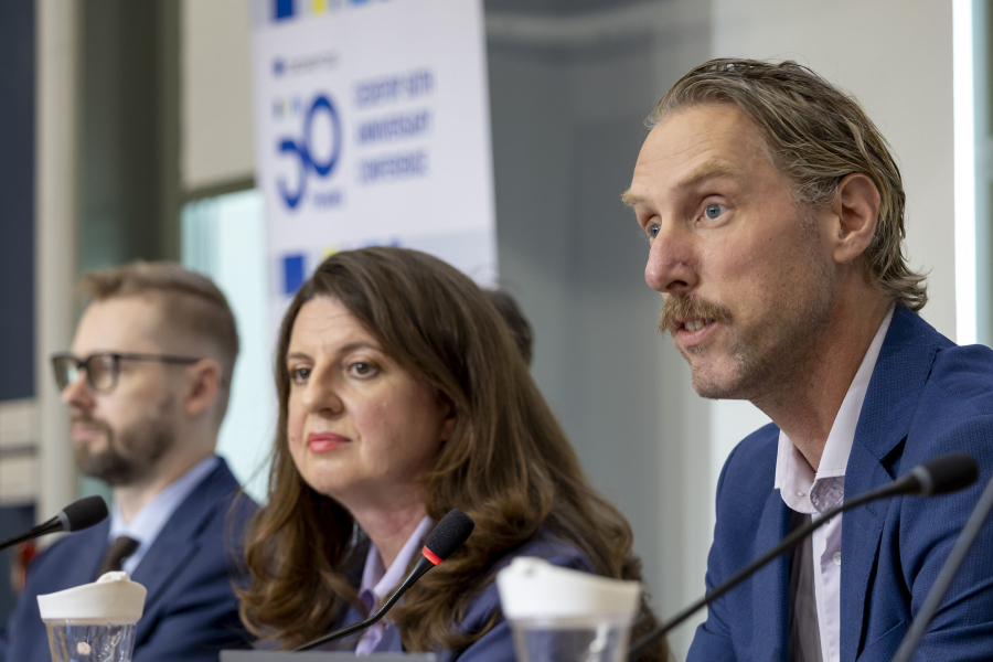 Two men and a woman in a panel