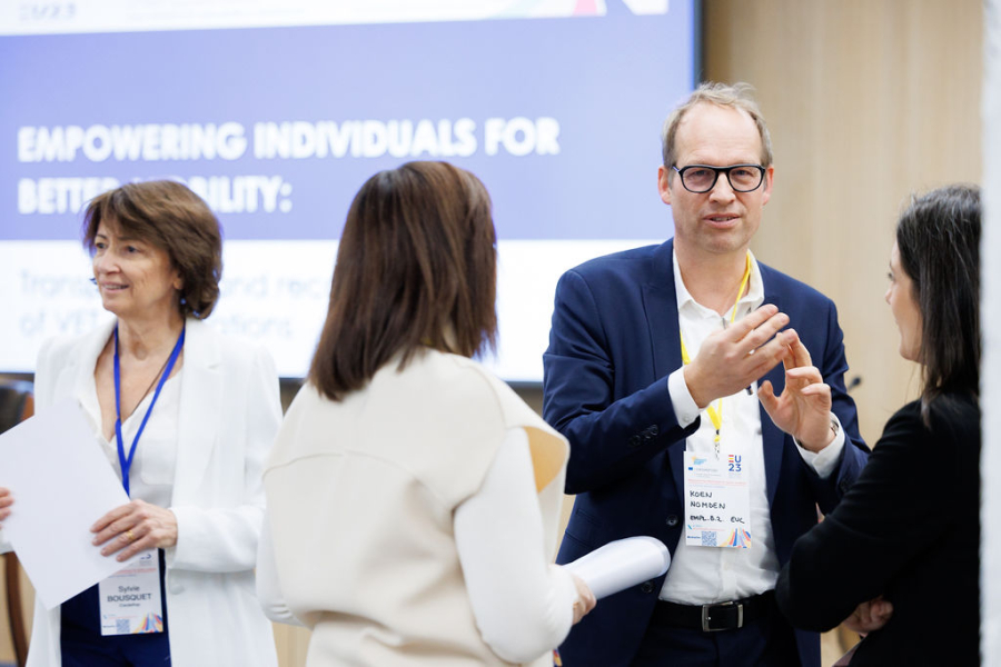 People talking in front of presentation screen