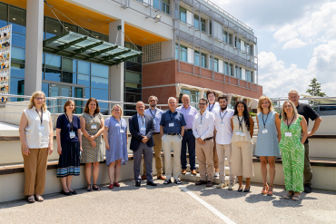 Family photo of participants at the 4th policy learning forum on learning outcomes outside the Cedefop building